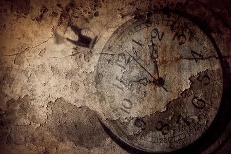 Closeup of hands on grunge clock faceの写真素材