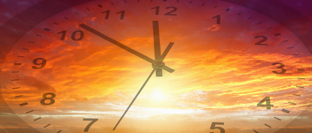 Clock face in bright sky. Time passingの写真素材