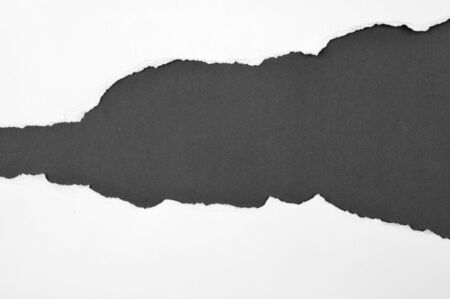 Hole ripped in paper on grey