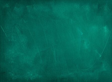 Chalk rubbed out on green chalkboard backgroundの写真素材