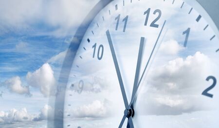 Clock face in blue sky. Time passing