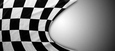 Checkered black and white flag on grey background. Copy space
