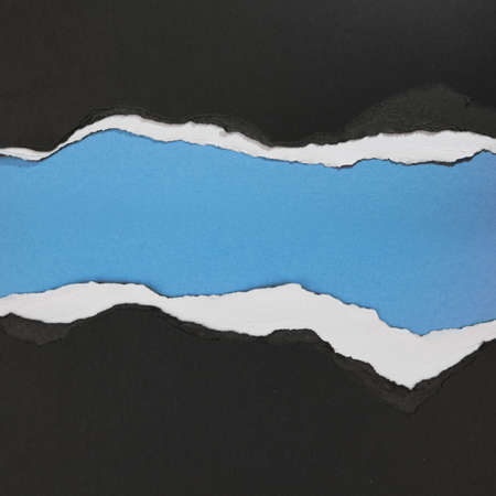 Ripped paper on blue background, space for copyの写真素材