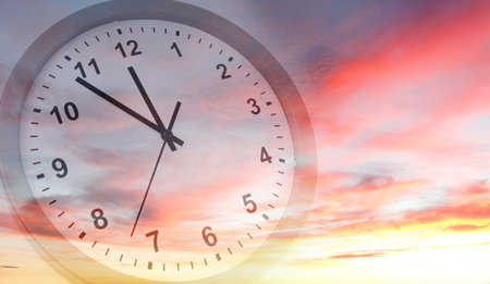 Clock face in bright sky. Time passingの写真素材