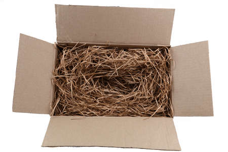 Shredded brown paper packaging in cardboard box