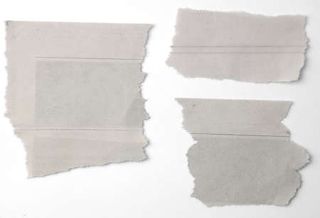 Three pieces of torn paper on plain background