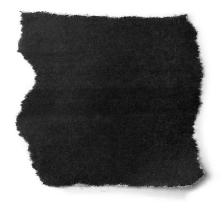 One black piece of torn paper on whiteの写真素材