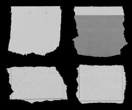 Four pieces of torn newspaper on black backgroundの写真素材