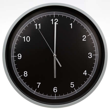 Wall clock showing six o'clock isolated on white backgroundの写真素材