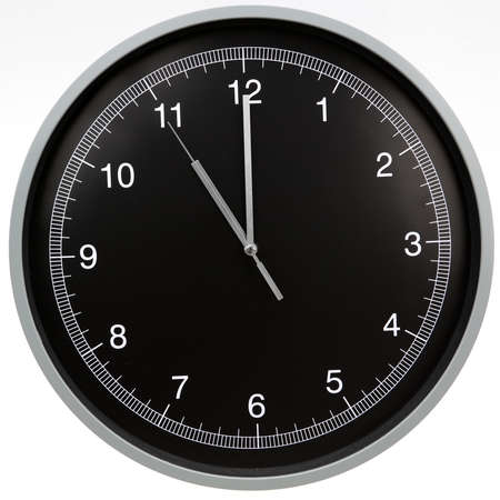 Wall clock showing eleven o'clock isolated on white backgroundの写真素材