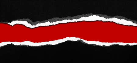 Hole ripped in paper on red backgroundの写真素材