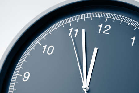 Closeup of hands on clock face. 12 o'clockの写真素材