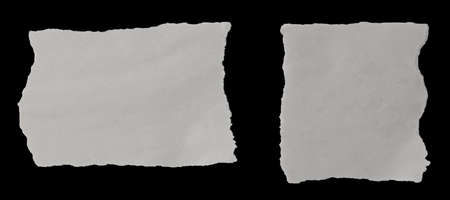 Two pieces of torn newspaper on black backgroundの写真素材