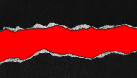 Hole ripped in paper on red backgroundの写真素材