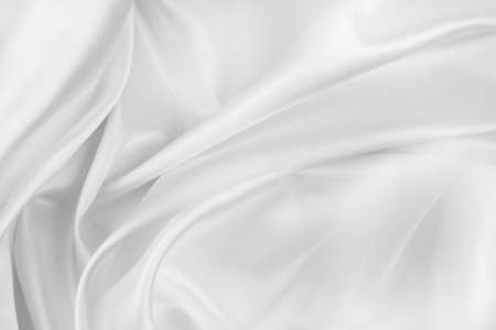 Close-up of rippled white silk fabric texture backgroundの写真素材
