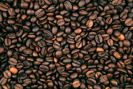 Close-up of roasted brown coffee beans backgroundの写真素材