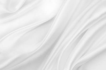 Close-up of rippled white silk fabric texture backgroundの写真素材