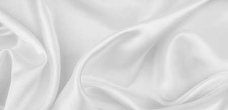 Close-up of rippled white silk fabric texture backgroundの写真素材