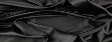 Closeup of rippled black silk fabricの写真素材