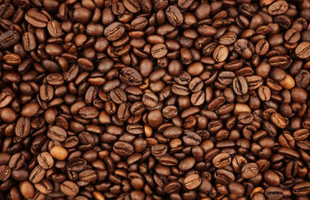 Close-up of roasted brown coffee beans backgroundの写真素材