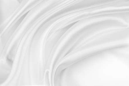 Close-up of rippled white silk fabric texture backgroundの写真素材