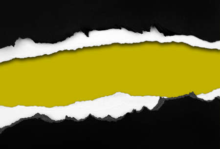 Ripped black paper on yellow background, space for copyの写真素材