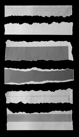 Six pieces of torn newspaper on black backgroundの写真素材