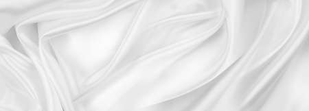 Close-up of rippled white silk fabric texture backgroundの写真素材