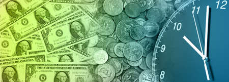 Clock and assorted American coins banknotes. Time is money ideaの写真素材