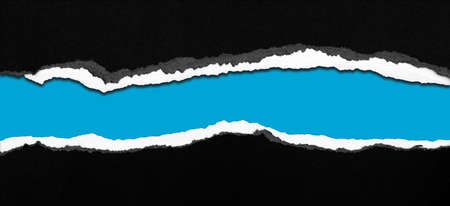 Ripped black paper on blue background, space for copyの写真素材