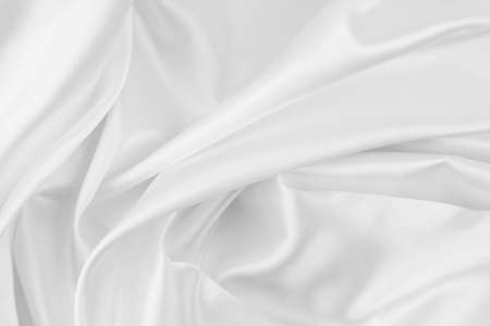 Close-up of rippled white silk fabric texture backgroundの写真素材