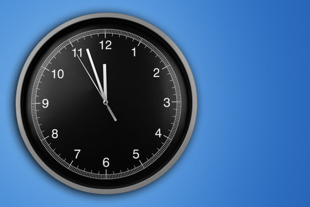 Wall clock showing twelve o'clock on blue background.の写真素材