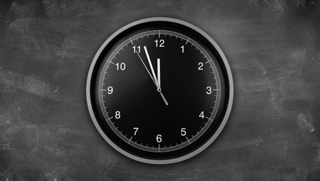 Clock showing twelve o'clock on chalkboardの写真素材