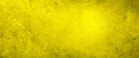 Yellow textured concrete wall wide backgroundの写真素材