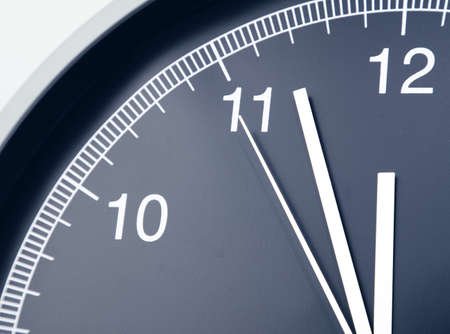 Closeup of hands on clock face.の写真素材