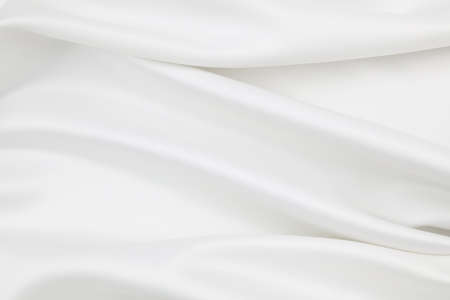 Close-up of rippled white silk fabric texture backgroundの写真素材