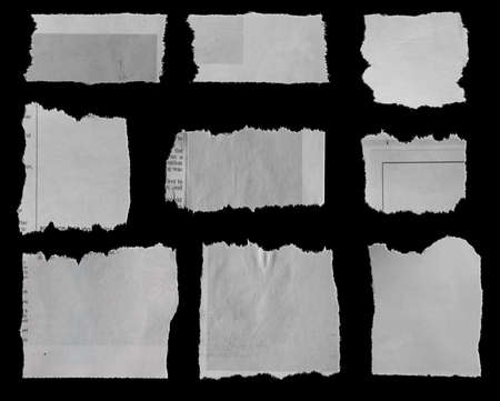 Nine pieces of torn newspaper on black backgroundの写真素材