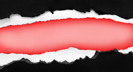 Hole ripped in paper on red backgroundの写真素材
