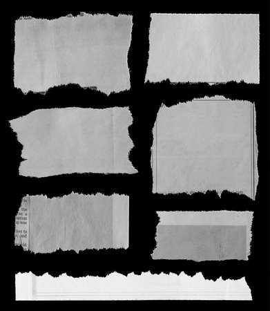 Seven pieces of torn newspaper on black backgroundの写真素材