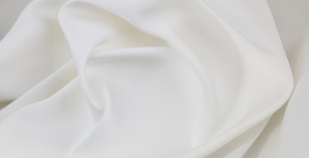 Close-up of rippled white silk fabric texture backgroundの写真素材