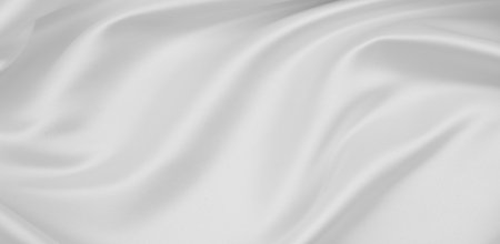 Close-up of rippled white silk fabric texture backgroundの写真素材