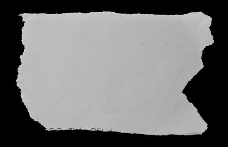 Piece of torn paper on blackの写真素材