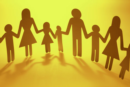 Family paper chain cutout holding handsの写真素材