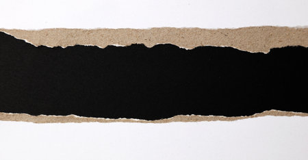 Ripped paper edges on black backgroundの写真素材