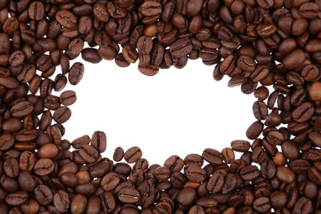 Closeup of roasted brown coffee beans on plain background. Copy spaceの写真素材