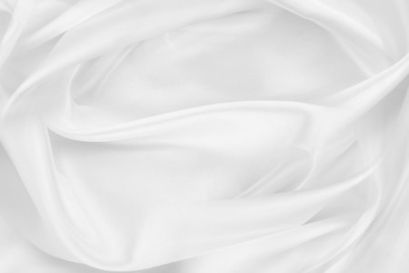 Rippled white silk fabric texture backgroundの写真素材
