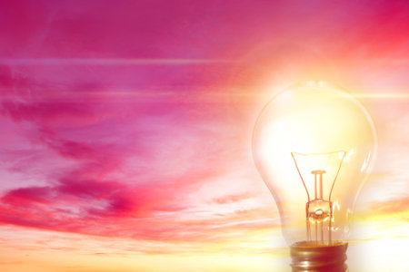 One bright light bulb and skyの写真素材