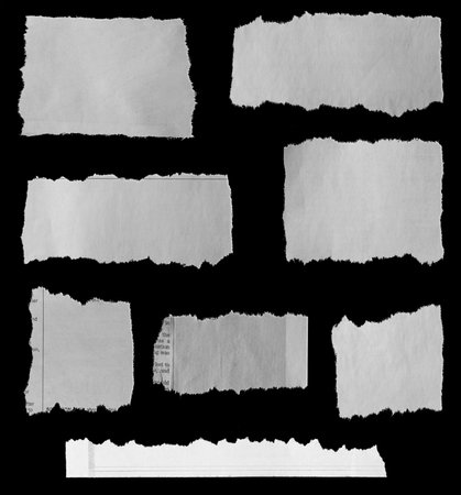Eight pieces of torn newspaper on black backgroundの写真素材