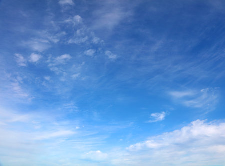 Fluffy white clouds in a blue skyの写真素材