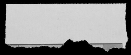 Piece of torn paper on blackの写真素材